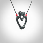 Hand carved Black Jade couples kissing in the shape of a heart pendant. Contemporary design is black jade. Pendants for lovers. Provided with adjustable cord.